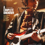 Official poster for A Complete Unknown, featuring Timothee Chalamet as Bob Dylan on the right side of the poster, holding a Fender stratocaster and facing to the right edge of the poster. On the left side is the movie title and a slew of credits.